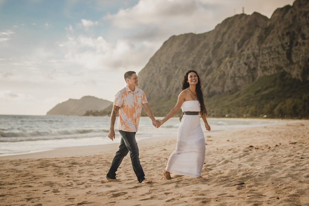 Couple walking along a beautiful beach in Hawaii.