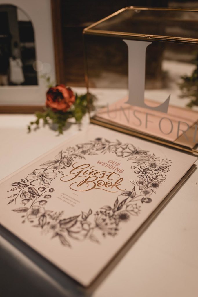 white guest sign-in book at wedding reception