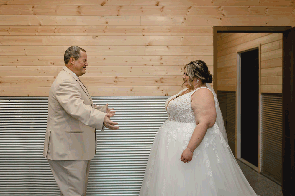 Bride and father of the bride hugging after seeing each other for the first time