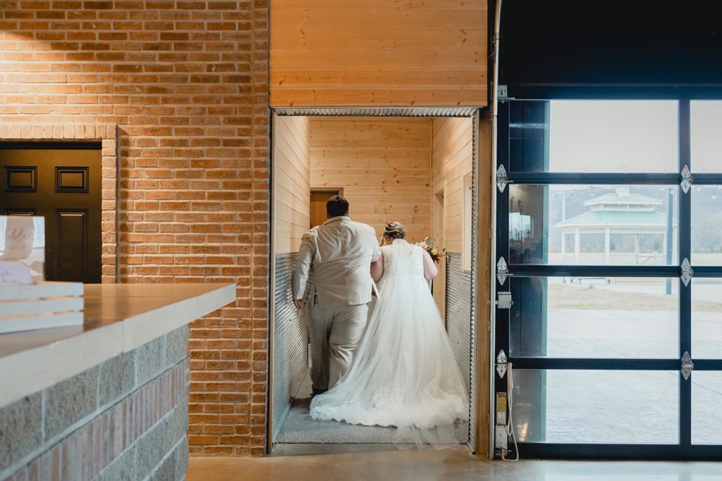 Bride and groom walking down hallway together