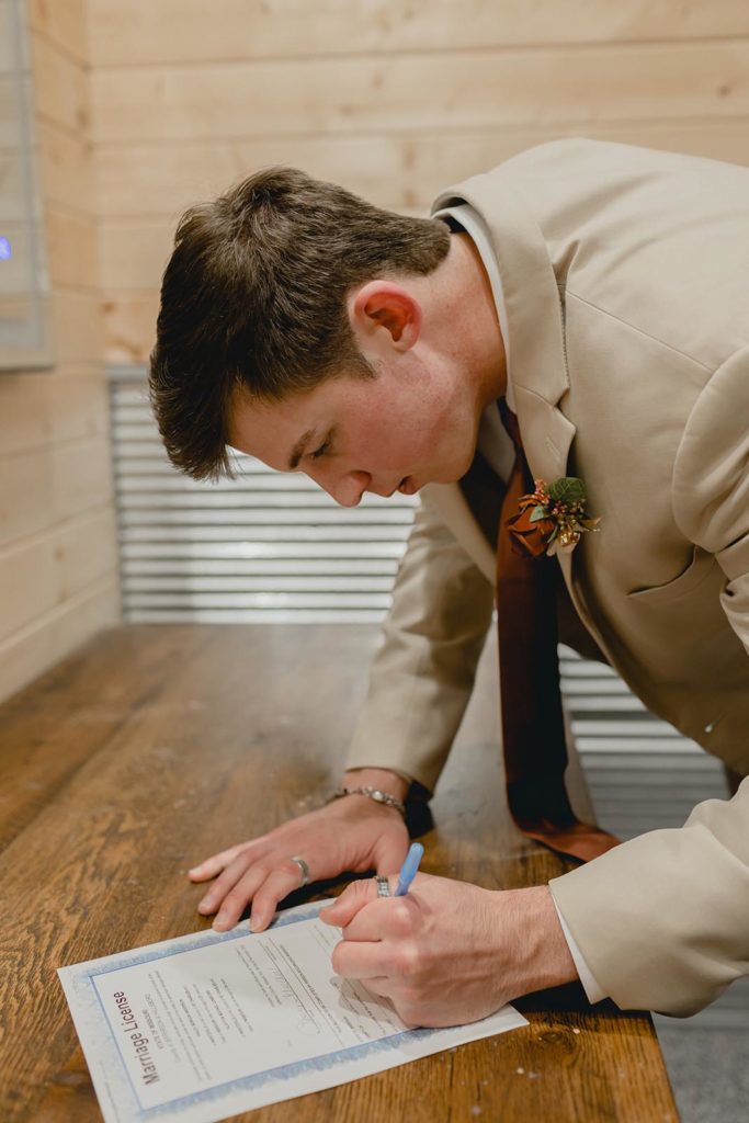 Best Man signing wedding license