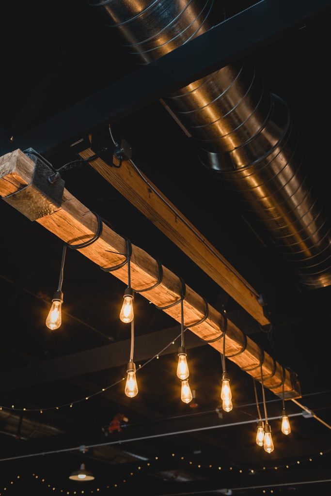 Wooden beam chandelier with string lights
