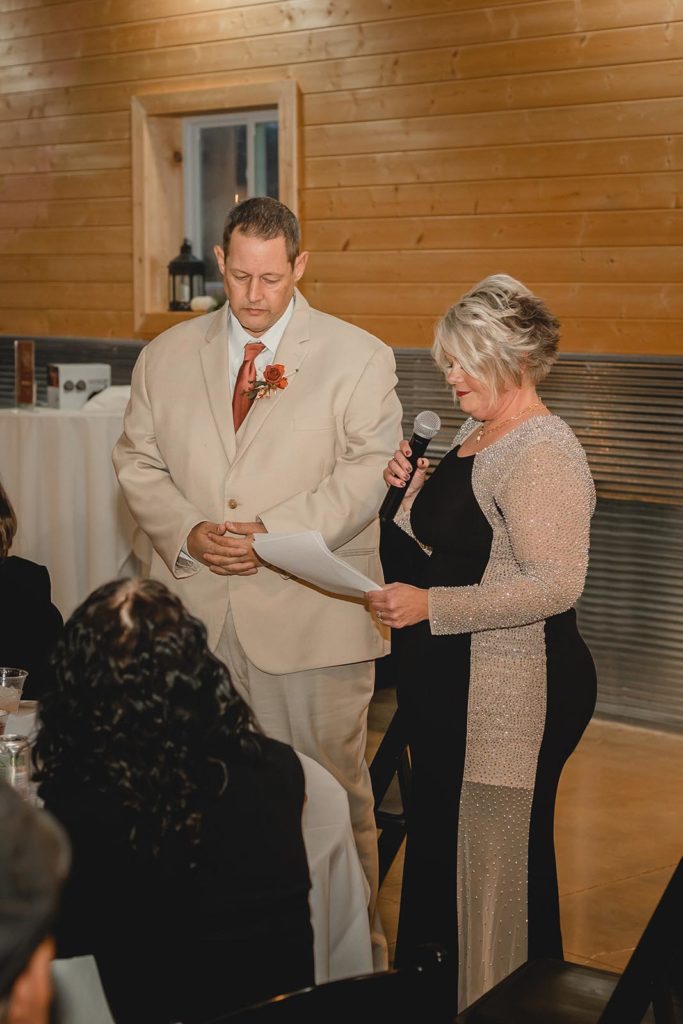 Mother and father of the bride giving a speech at wedding reception