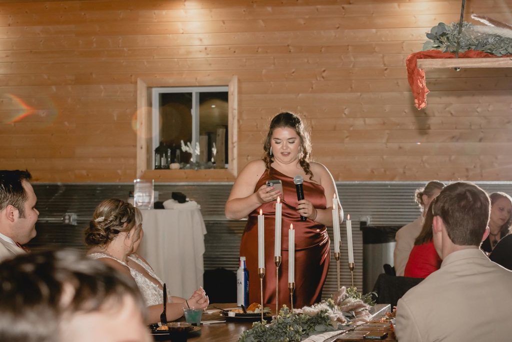 Maid of honor giving speech at wedding reception