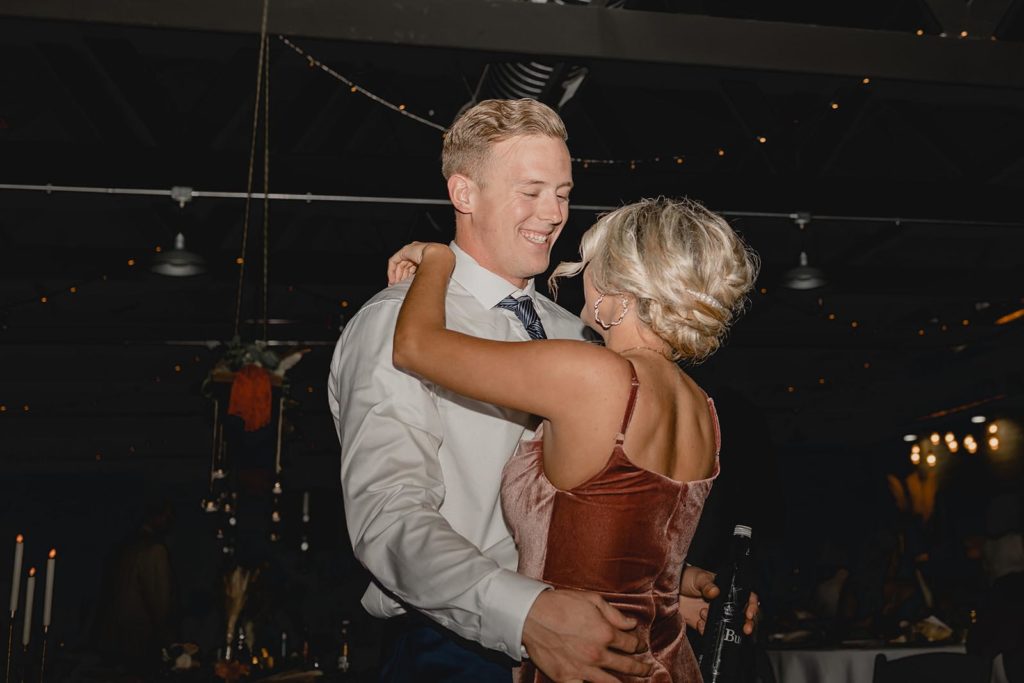 Bridesmaid and her date dancing together at wedding reception