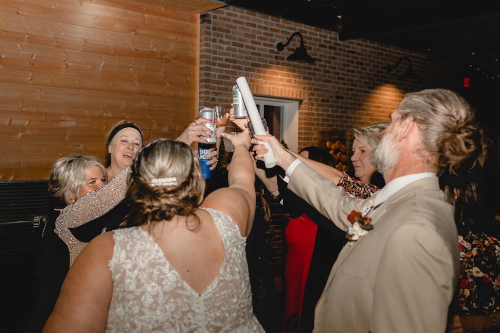Wedding guest toasting drink during wedding reception with bride