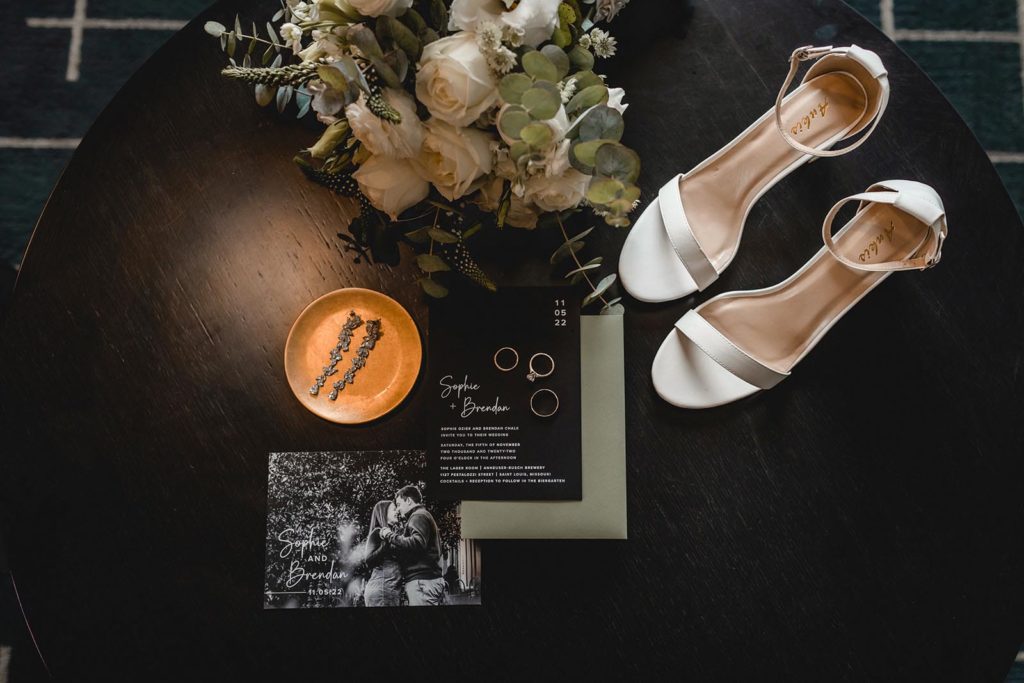 wedding day details including shoes, rings, and invitation