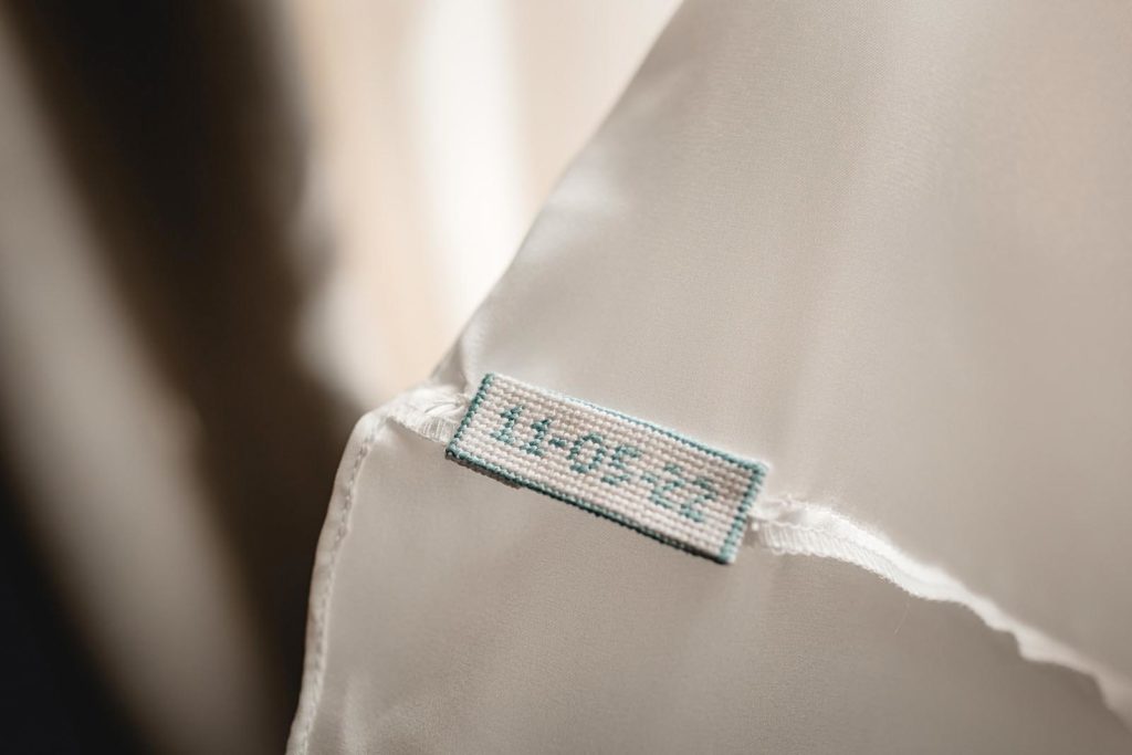 Wedding dress detail shot with embrodered date