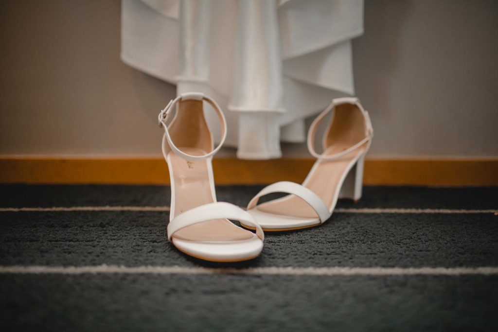 Bride shoes infront of wedding dress