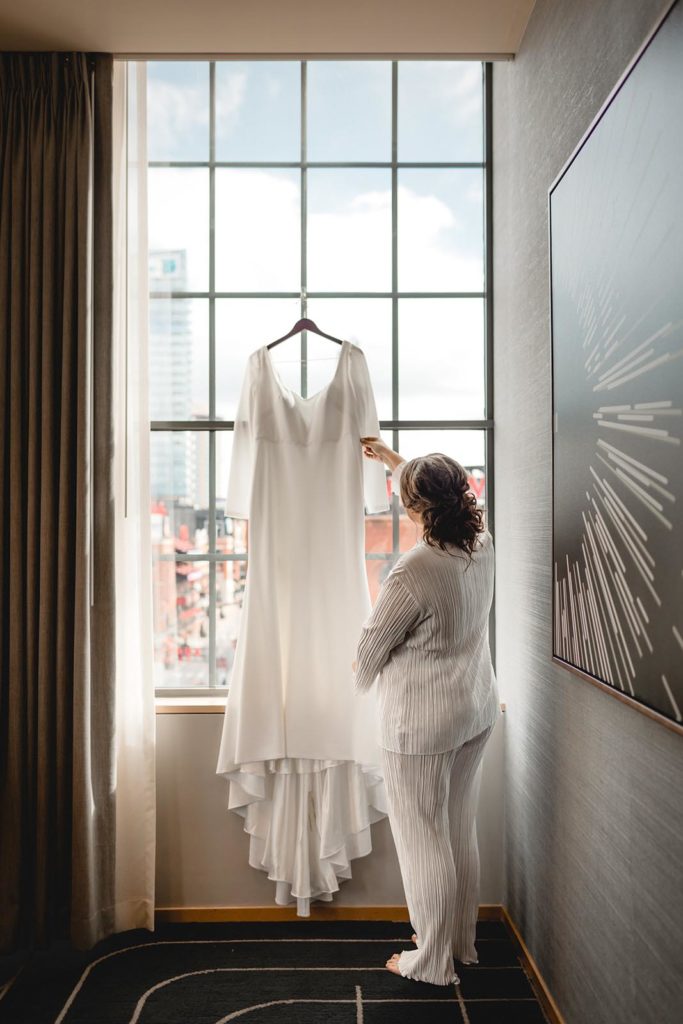 Bride and dress infront of window