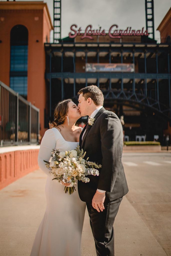 Bride and groom kissing at Busch stadium in St. Louis
