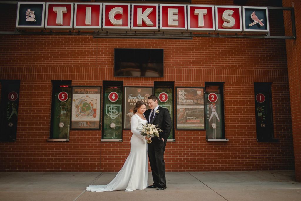 Bride and groom posing infront of busch stadium