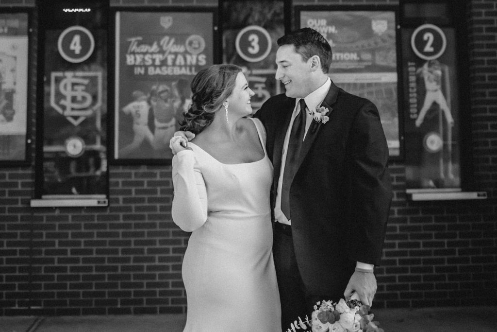Black and white photo of bride and groom at busch statium on wedding day