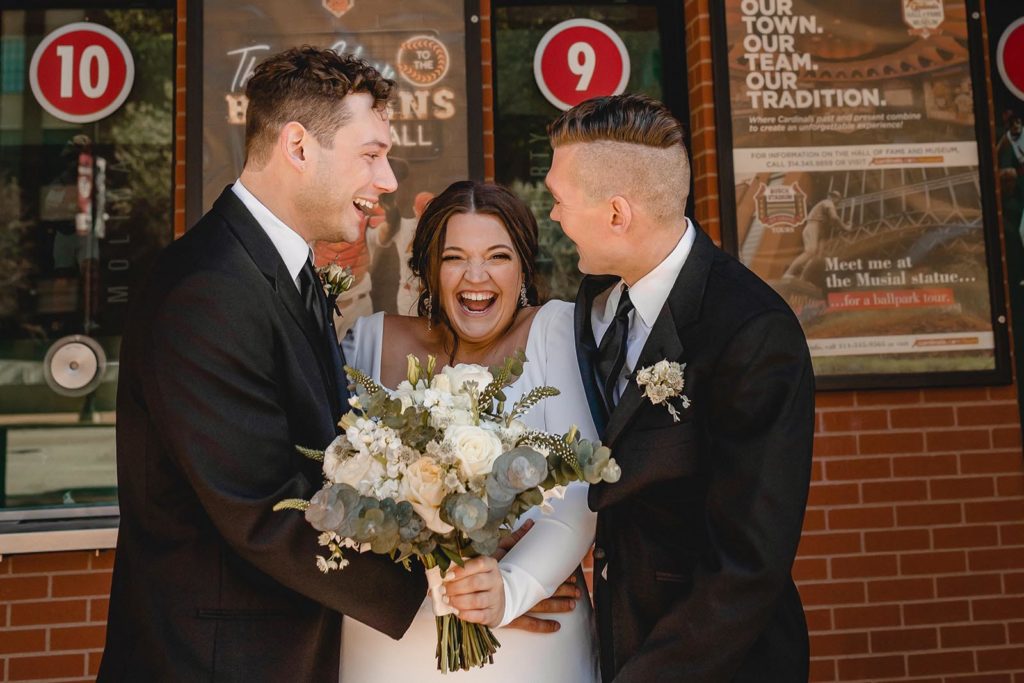 Bride and groomsment lauging at busch stadium st. louis