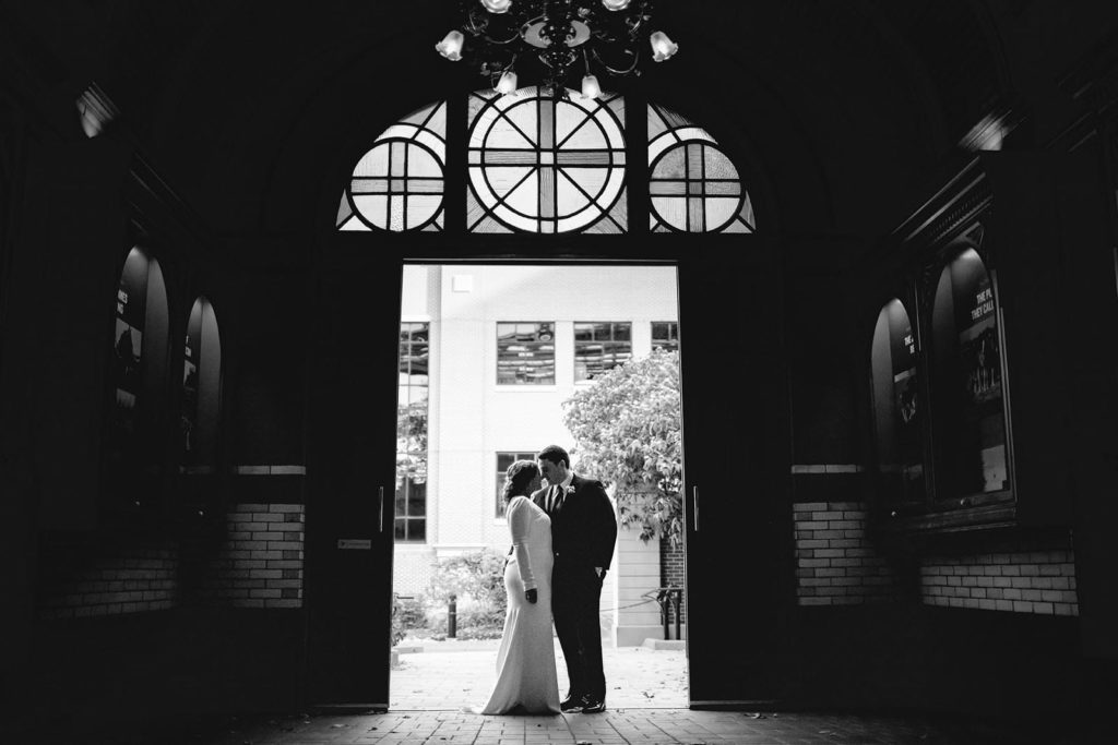 Black and white couple posing at Anheuser Busch Brewer in open doorway
