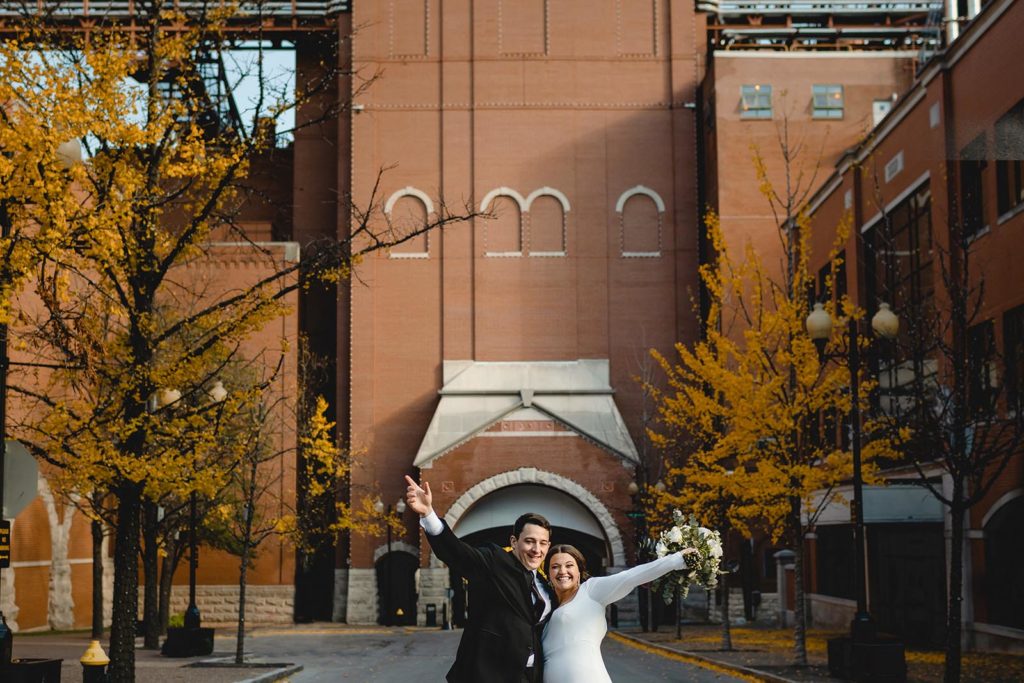 Bride and groom posing infront of Anheuser Busch Brewery