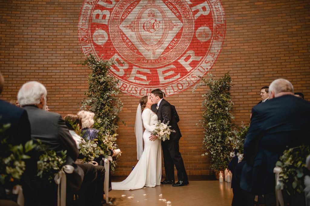 Bride and groom first kiss at Anheuser Busch wedding