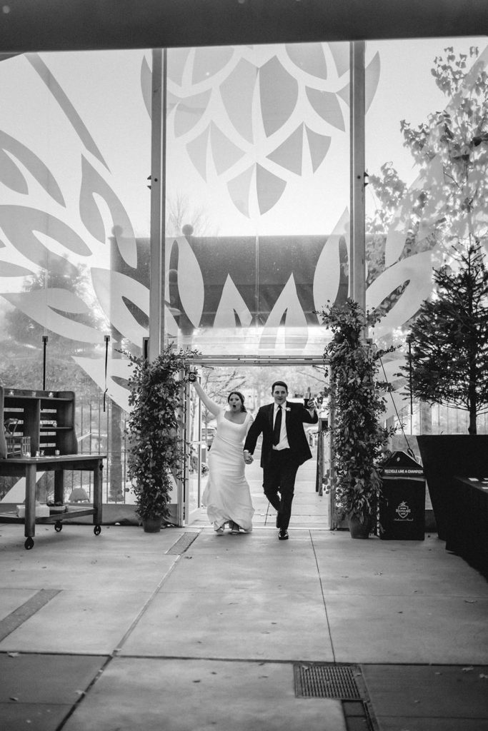 Bride and groom arriving to their reception at Anheuser Busch Brewery black and white