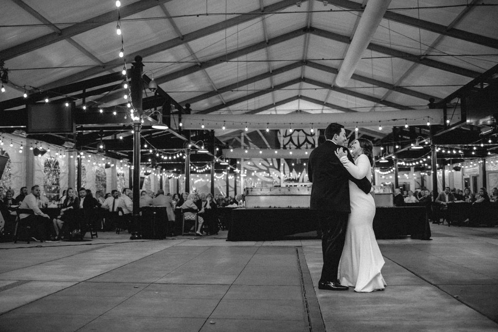 Black and white first dance of bride and groom at Anheuser Busch Biergarden in St. Louis