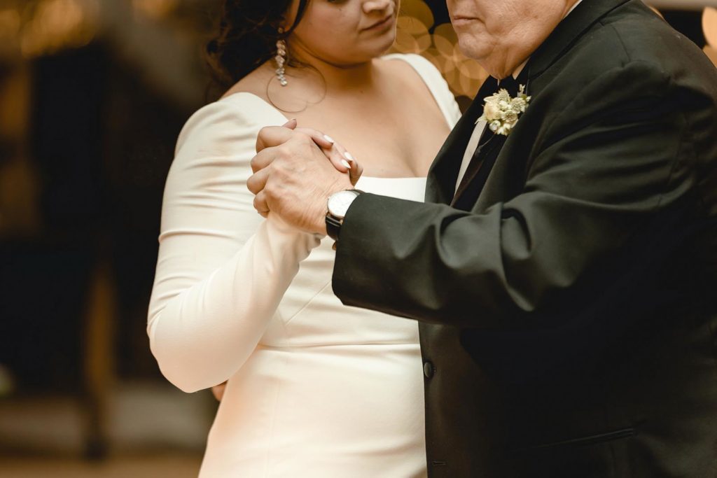 Father daughter wedding dance holding hands
