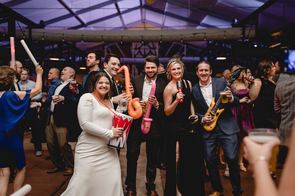 Guest dancing at Anheuser Busch Brewery wedding with inflatible instruments
