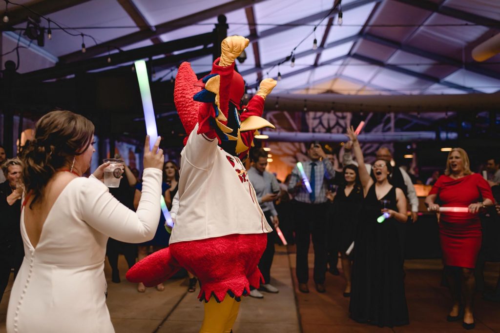 St. Louis cardinals mascot fredbird suprising bride and groom at reception