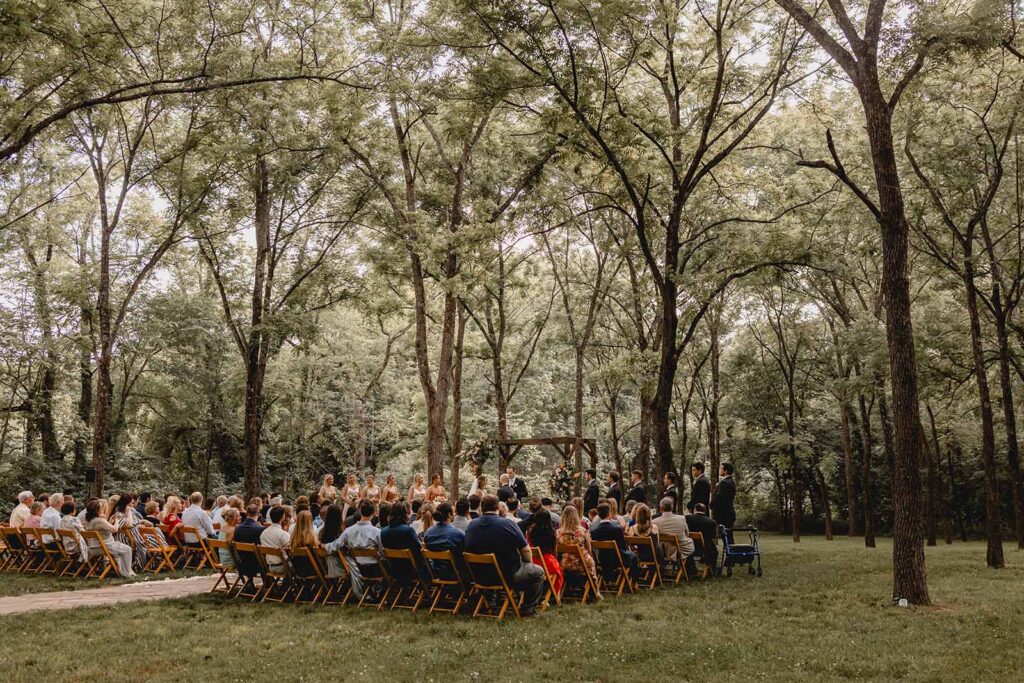 Wide shot of summer outdoor wedding in Walnut Grove at Lost Hill Lake