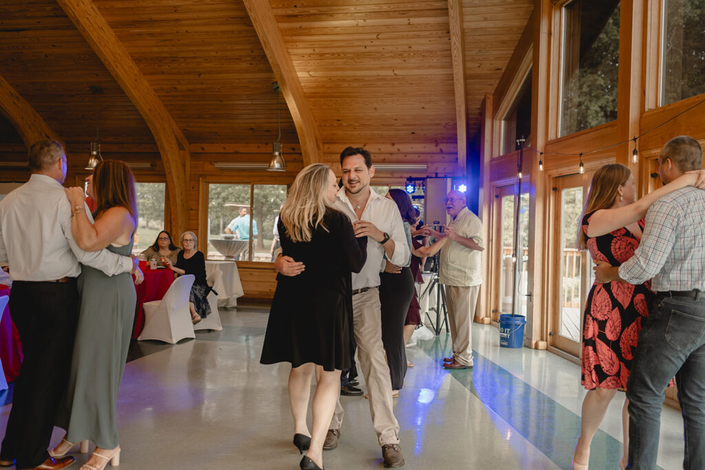 wedding guests dance the in the indoor late afternoon dance floor