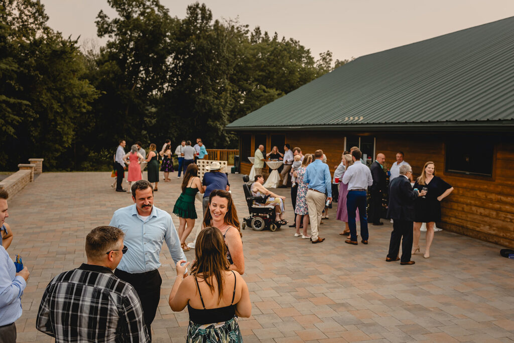 wedding guests mingle on the outdoor patio