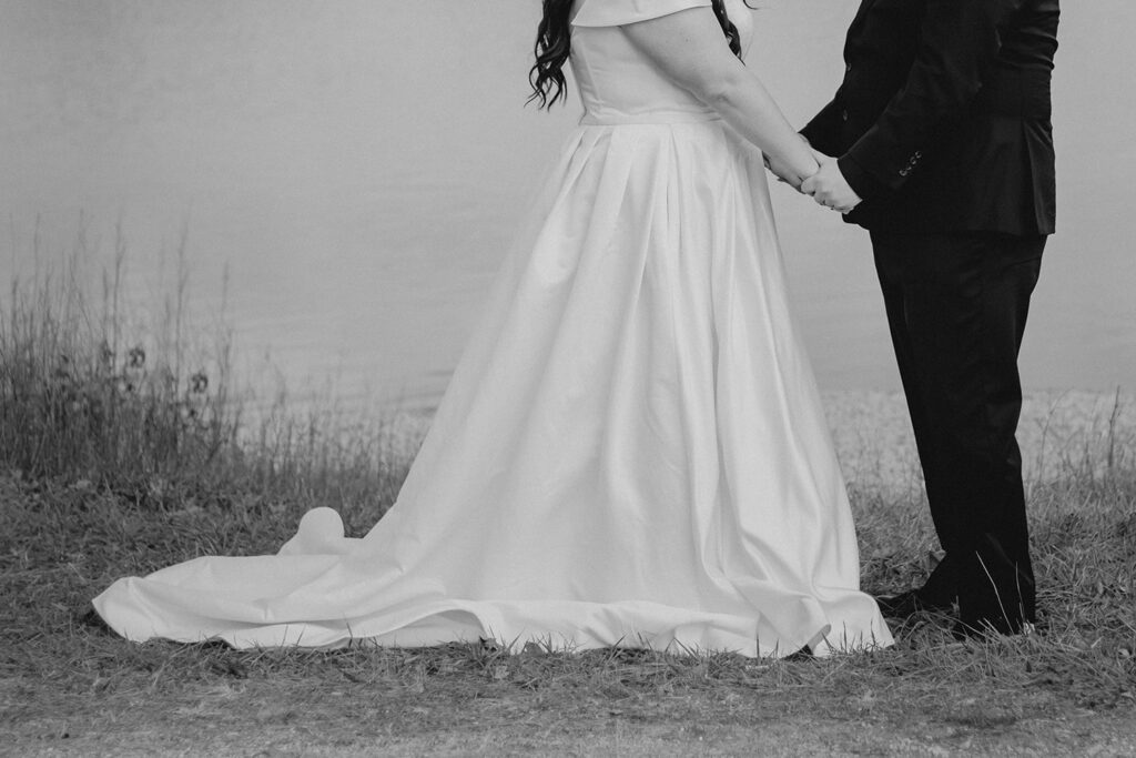 artsy black and white close up bride and groom holding hands