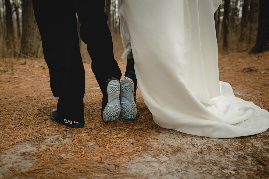 close up of bottom of bride and groom's matching blue shoe soles