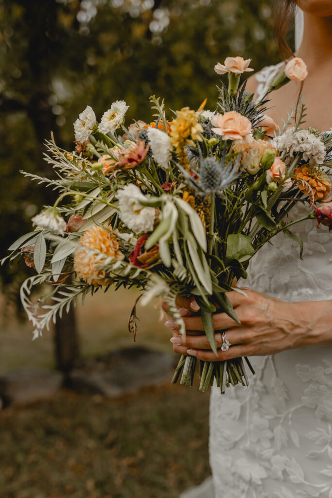 Close up photo of bridal bouquet in brides hands.