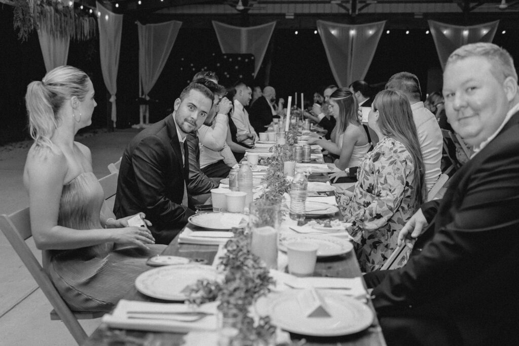 Guest seated at family style tables during wedding reception.