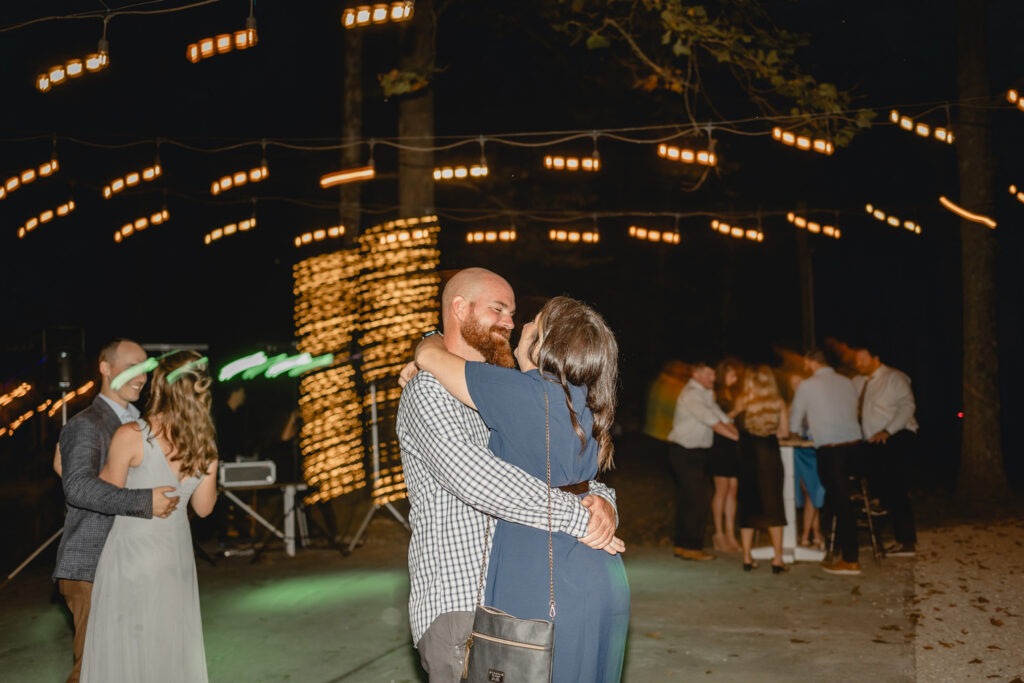 Couple embracing at wedding reception dance.