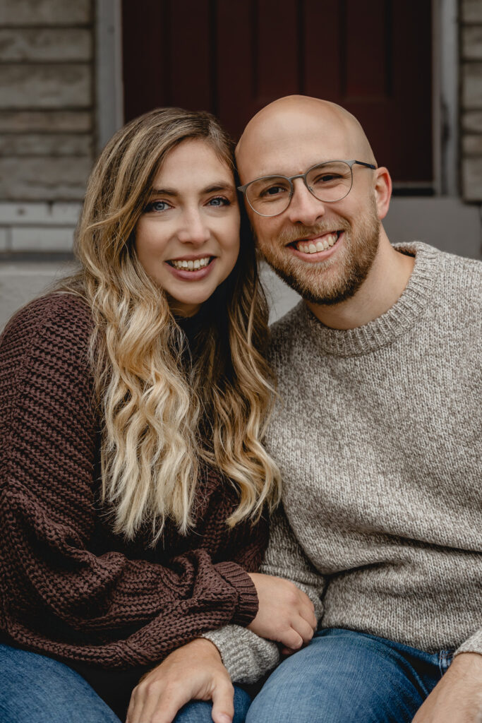 close up portrait of young couple close together and smiling towards the camera