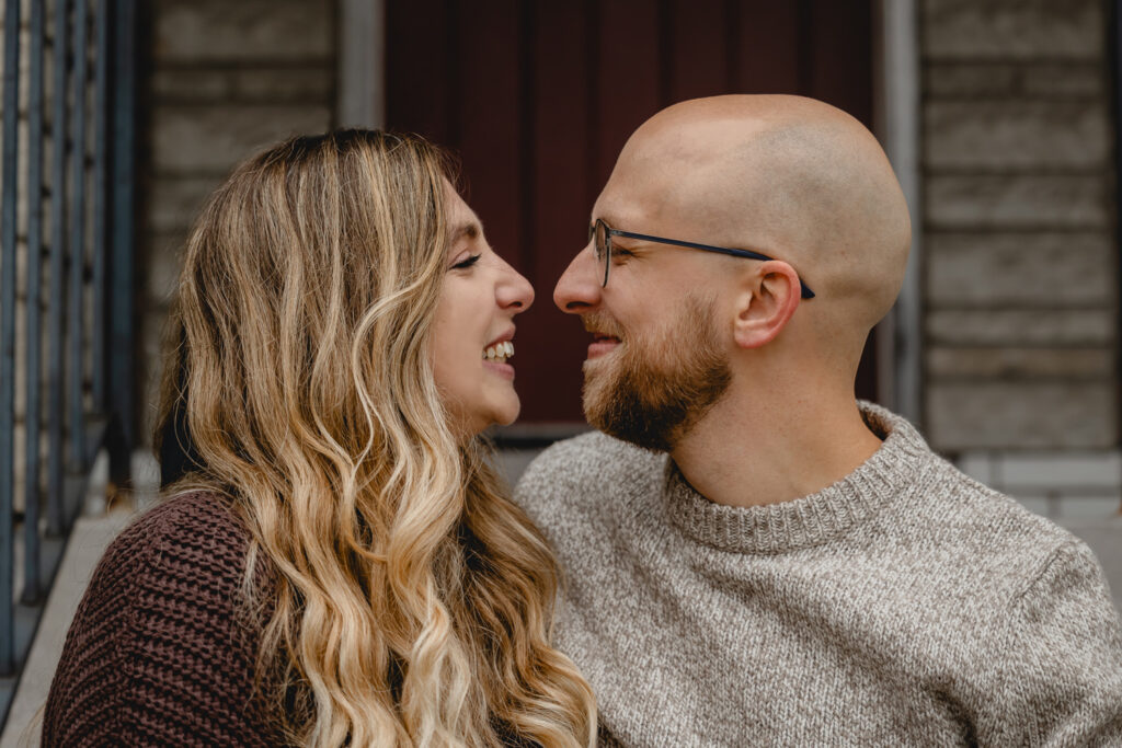 close up of couple smiling as they nuzzle noses together